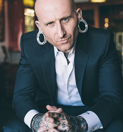 Brian Keith Thompson of Body Electric TattooThompson, a U.S. Marine Corps veteran, took the Corps’ “adapt and overcome” motto to heart.